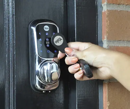 Keyless electronic Yale door lock with backlit number pad and key fob being used – smart lock installation by Dee Valley Locksmiths serving Wrexham, Chester and Shrewsbury